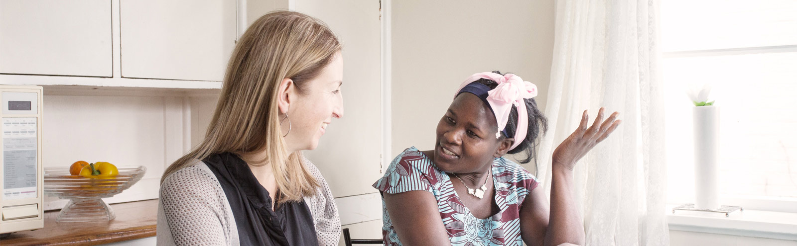 Two women seated, talking